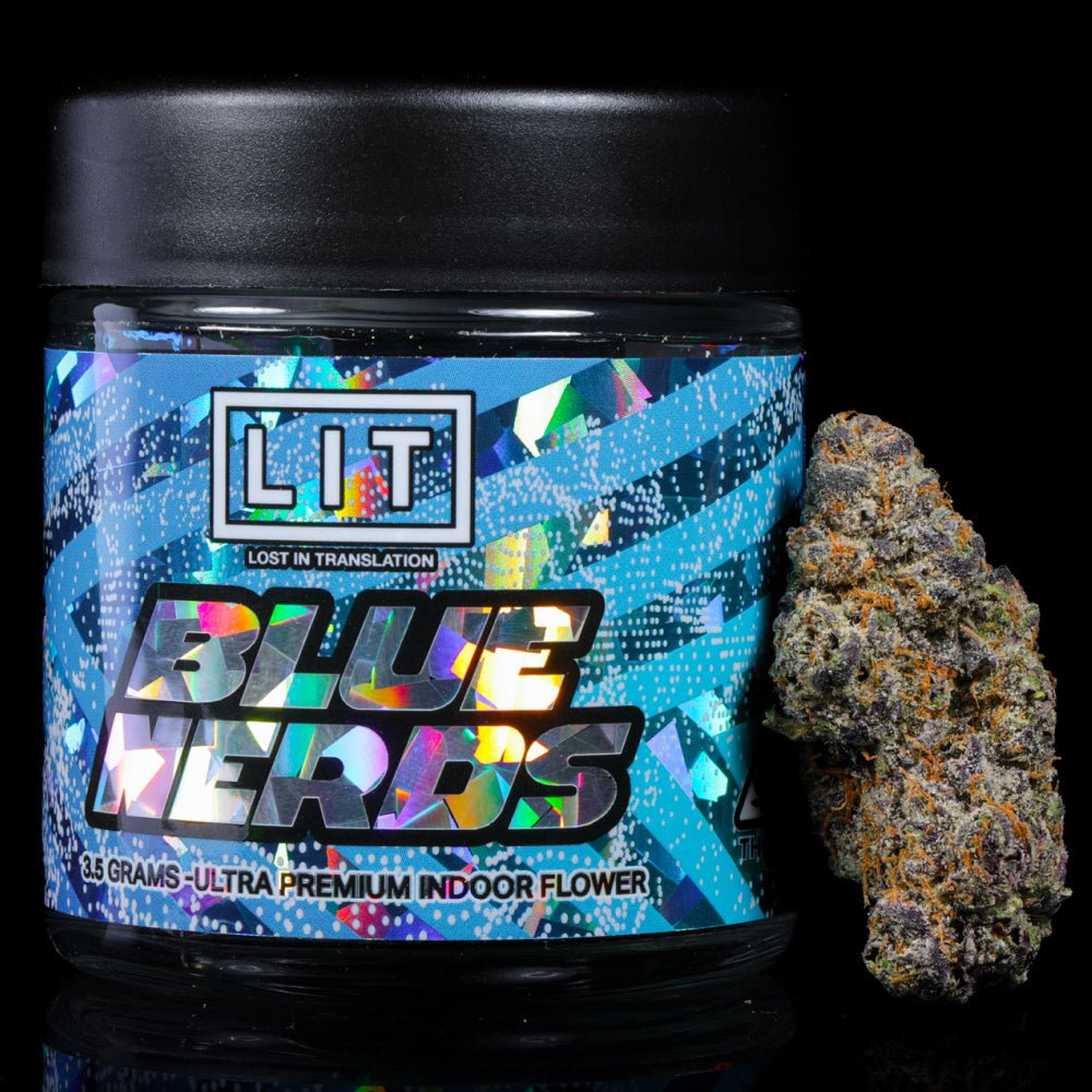 Jar of Blue Kerries ultra premium indoor flower with colorful holographic label next to a cannabis bud nugget